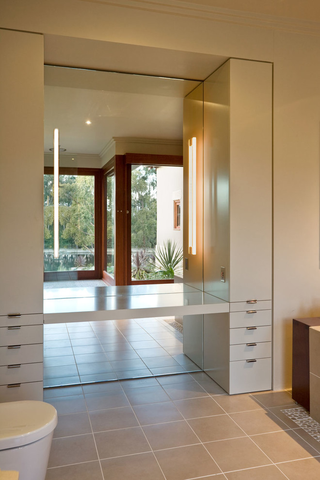 Inspiration for a large modern ensuite bathroom in Sydney with flat-panel cabinets, beige cabinets, beige tiles, ceramic tiles, beige walls and ceramic flooring.