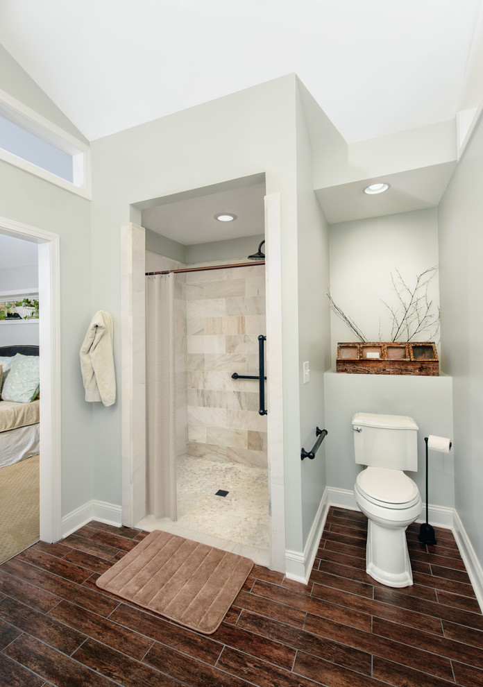 Idee per una stanza da bagno padronale chic di medie dimensioni con doccia alcova, WC a due pezzi, piastrelle grigie, pareti grigie, pavimento in laminato, pavimento marrone e porta doccia a battente