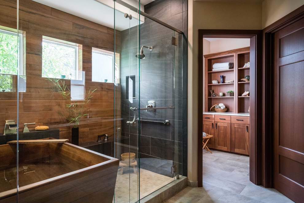 Design ideas for a classic ensuite bathroom in Portland with black tiles, brown tiles, a freestanding bath, an alcove shower, porcelain tiles, beige walls, porcelain flooring, beige floors and a hinged door.