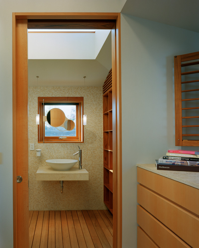 Imagen de cuarto de baño actual con lavabo sobreencimera, armarios abiertos, puertas de armario de madera en tonos medios, encimera de piedra caliza, ducha a ras de suelo, baldosas y/o azulejos amarillos y baldosas y/o azulejos en mosaico