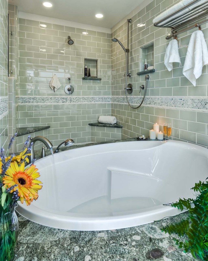 На фото: ванная комната в современном стиле с плиткой кабанчик и душем над ванной с