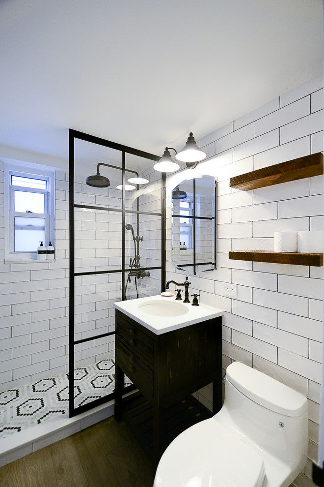 Photo of a medium sized urban bathroom in New York with freestanding cabinets, brown cabinets, a double shower, a one-piece toilet, white tiles, metro tiles, white walls, porcelain flooring, a pedestal sink, brown floors, an open shower and white worktops.