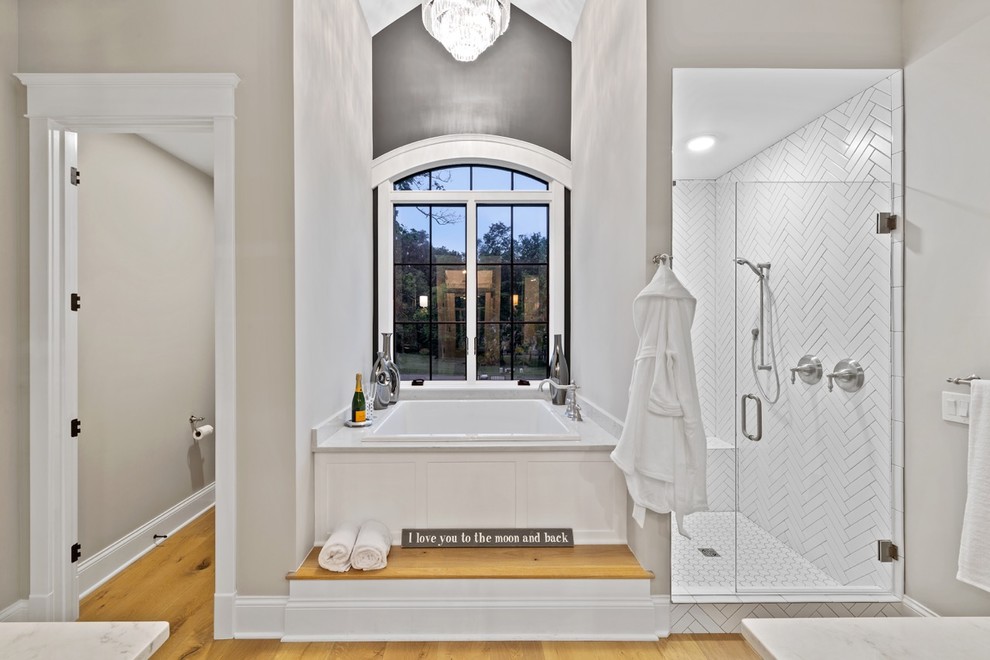 Mittelgroßes Klassisches Badezimmer En Suite mit japanischer Badewanne, weißen Fliesen, grauer Wandfarbe, hellem Holzboden, Quarzwerkstein-Waschtisch, Falttür-Duschabtrennung und weißer Waschtischplatte in Cincinnati