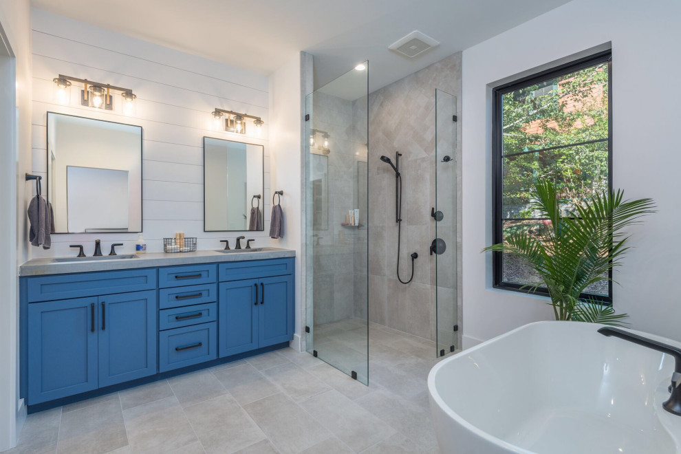 Inspiration for a medium sized contemporary ensuite bathroom with recessed-panel cabinets, blue cabinets, a freestanding bath, a built-in shower, grey tiles, ceramic tiles, white walls, ceramic flooring, an integrated sink, concrete worktops, grey floors, an open shower and grey worktops.