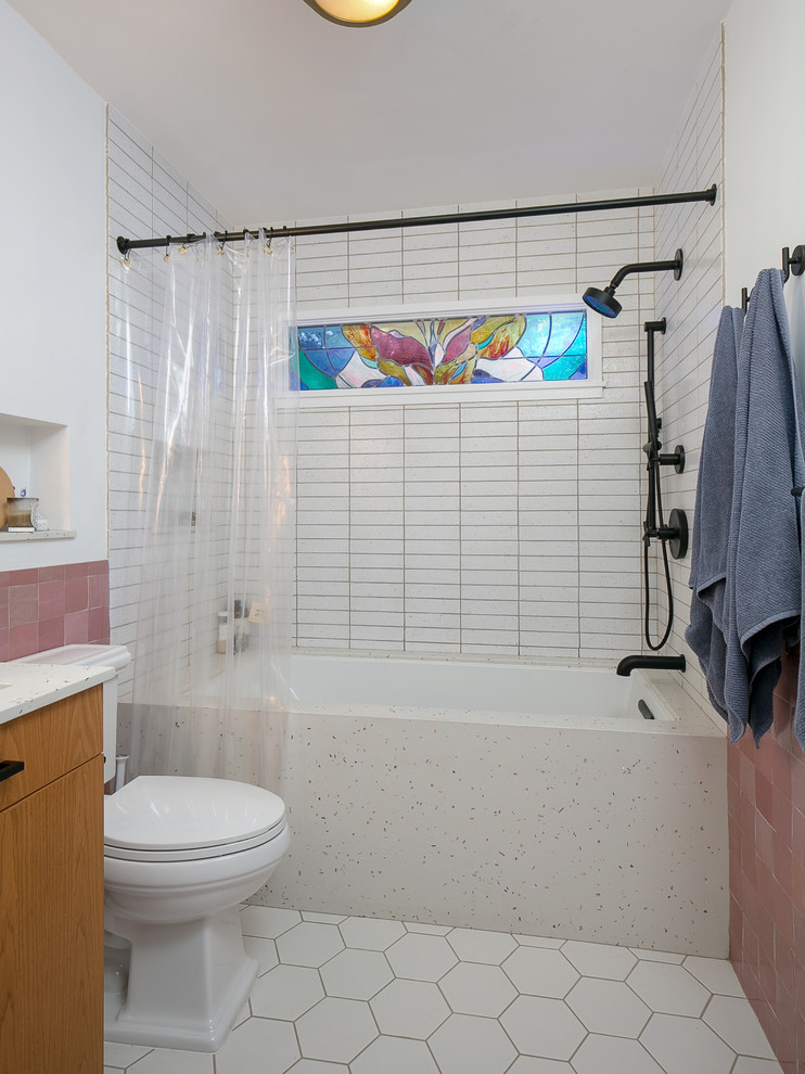 Стильный дизайн: главная ванная комната среднего размера в стиле неоклассика (современная классика) с плоскими фасадами, светлыми деревянными фасадами, полновстраиваемой ванной, душем над ванной, раздельным унитазом, розовой плиткой, керамогранитной плиткой, белыми стенами, полом из цементной плитки, врезной раковиной, столешницей из искусственного камня, белым полом, шторкой для ванной и белой столешницей - последний тренд