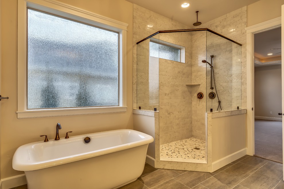 Inspiration for a large timeless master multicolored tile and pebble tile ceramic tile bathroom remodel in Boise with raised-panel cabinets, medium tone wood cabinets, a one-piece toilet, beige walls, quartz countertops and an undermount sink