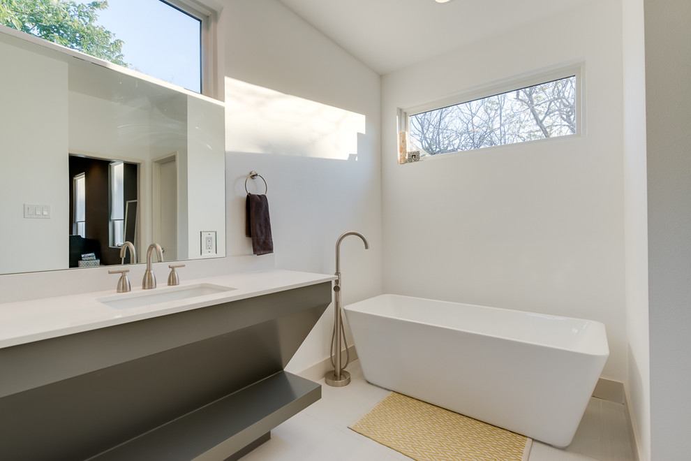Inspiration for a contemporary freestanding bathtub remodel in Dallas with white countertops