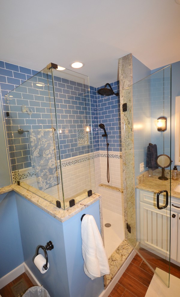 Alcove shower - coastal master blue tile and glass tile porcelain tile alcove shower idea in Philadelphia with an undermount sink, recessed-panel cabinets, white cabinets, granite countertops, a two-piece toilet and blue walls