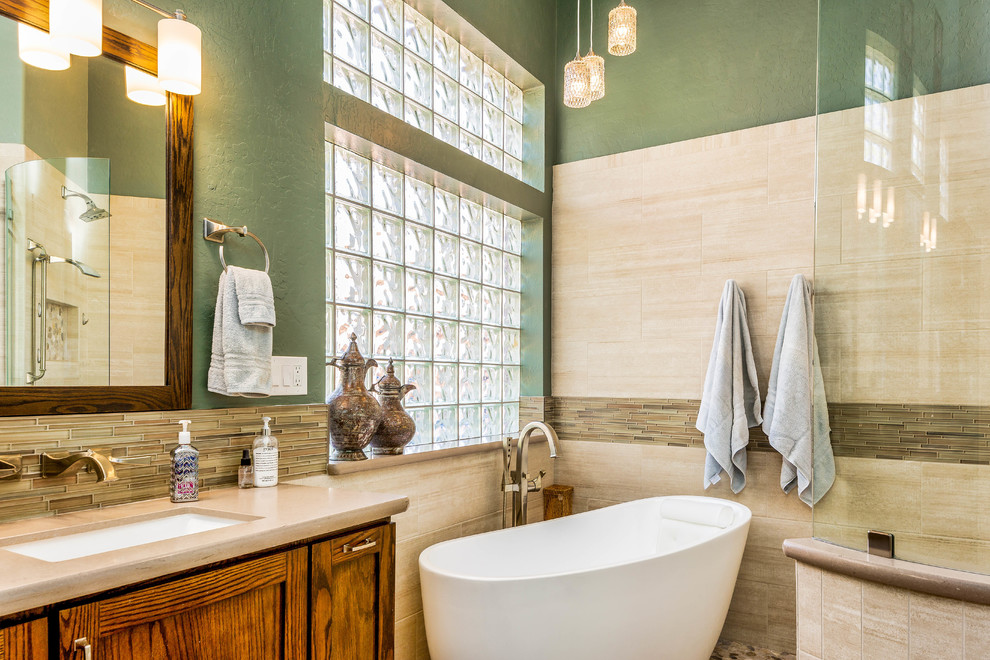 Inspiration for a large transitional master beige tile and porcelain tile porcelain tile and beige floor bathroom remodel in Phoenix with shaker cabinets, dark wood cabinets, a two-piece toilet, green walls, an undermount sink and quartz countertops