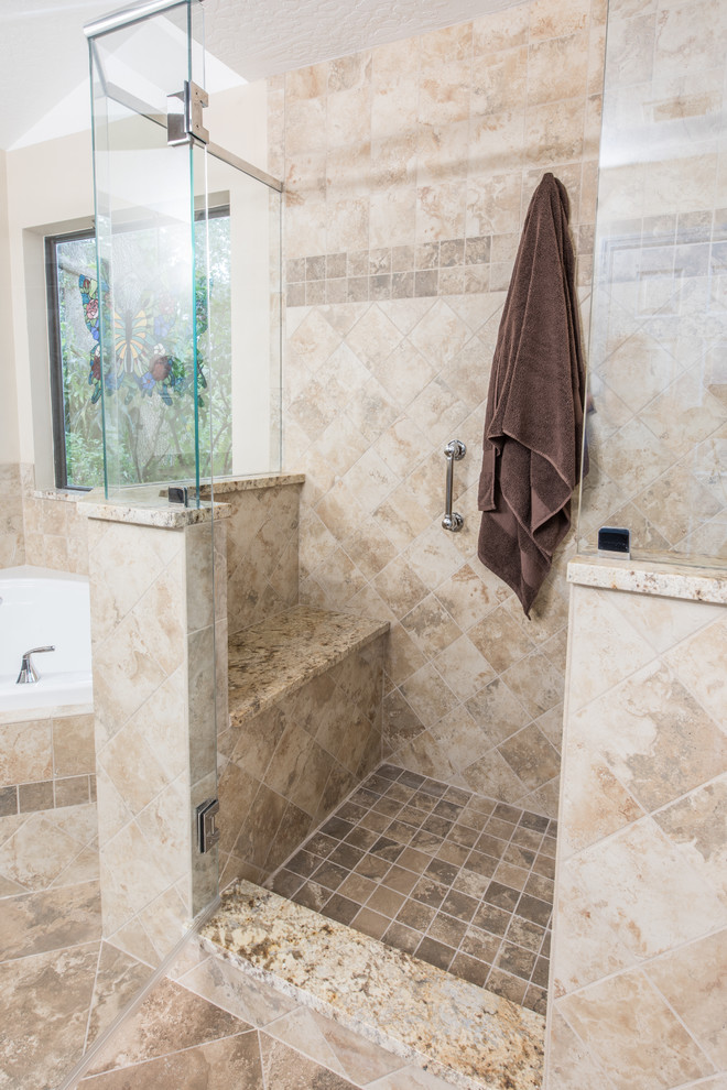 Inspiration for a mid-sized timeless master beige tile and porcelain tile porcelain tile and brown floor bathroom remodel in Orlando with recessed-panel cabinets, dark wood cabinets, a two-piece toilet, beige walls, an undermount sink, granite countertops and a hinged shower door
