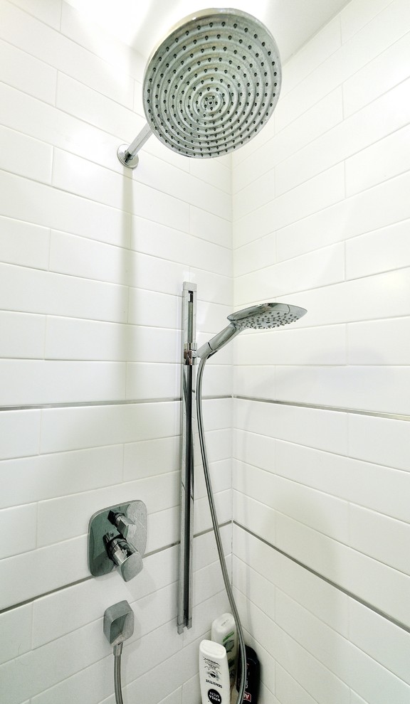 Example of a mid-sized minimalist master white tile and ceramic tile ceramic tile corner shower design in New York with a console sink, solid surface countertops and white walls