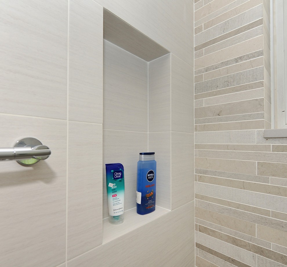 Inspiration for a mid-sized contemporary white tile and ceramic tile ceramic tile corner shower remodel in New York with an integrated sink, flat-panel cabinets, light wood cabinets, solid surface countertops, a one-piece toilet and white walls