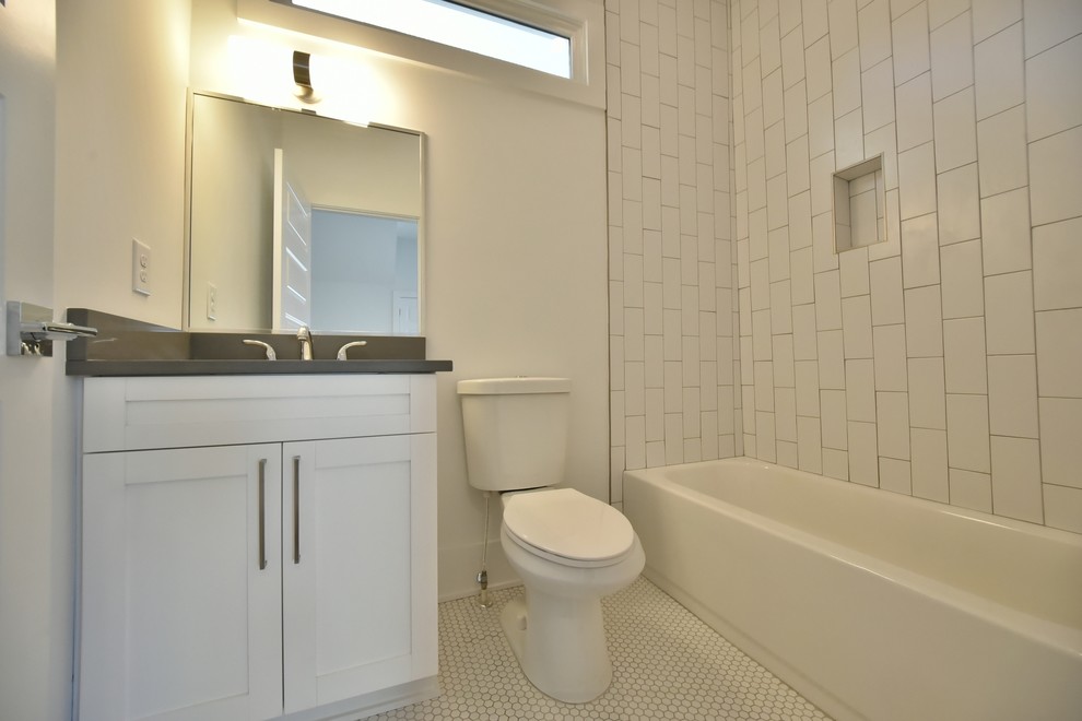 Example of a mid-sized transitional 3/4 white tile and subway tile porcelain tile bathroom design in Atlanta with shaker cabinets, white cabinets, a two-piece toilet, white walls, an undermount sink and zinc countertops