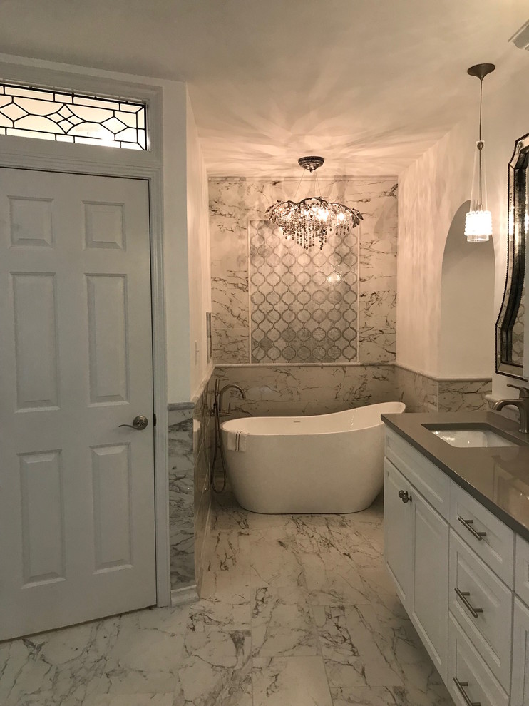 Large trendy master black and white tile and mosaic tile marble floor and white floor bathroom photo in Atlanta with shaker cabinets, white cabinets, a one-piece toilet, white walls, a console sink, quartz countertops, a hinged shower door and gray countertops