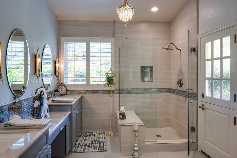 Inspiration for a mid-sized transitional master gray tile and porcelain tile porcelain tile corner shower remodel in San Diego with shaker cabinets, blue cabinets, blue walls, an undermount sink and marble countertops