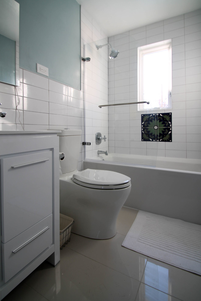 Example of a small trendy master white tile and porcelain tile porcelain tile bathroom design in Denver with shaker cabinets, white cabinets, a one-piece toilet, blue walls, an integrated sink and quartz countertops