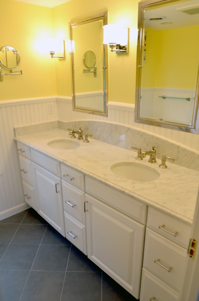 Inspiration for a small timeless 3/4 white tile ceramic tile bathroom remodel in Providence with raised-panel cabinets, white cabinets, marble countertops, a two-piece toilet, an undermount sink and yellow walls
