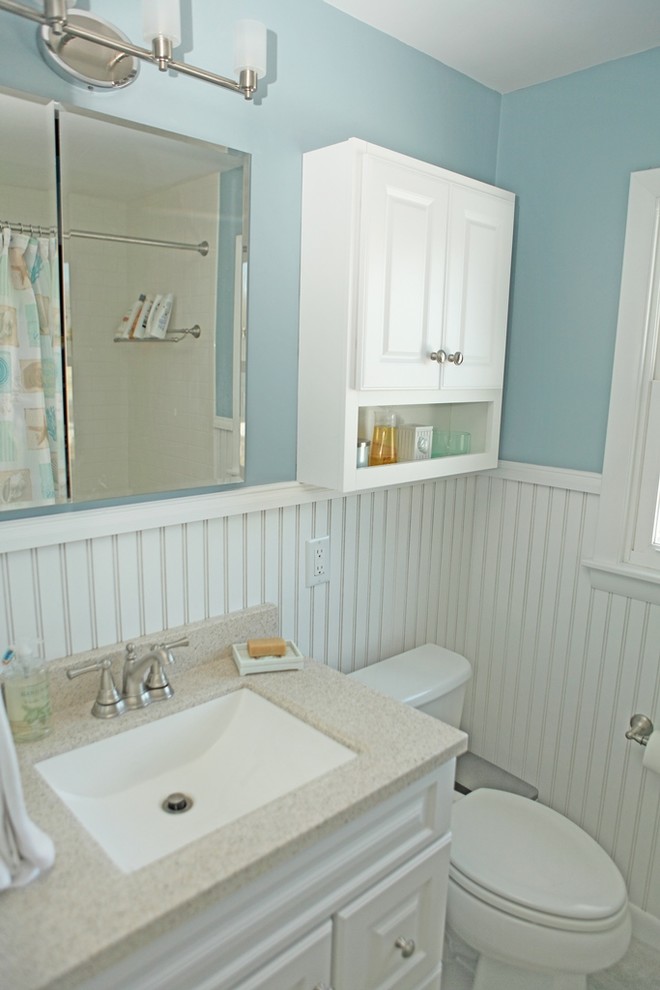 Inspiration for a mid-sized modern white tile and cement tile ceramic tile drop-in bathtub remodel in Providence with raised-panel cabinets, white cabinets, a one-piece toilet, blue walls, an undermount sink and granite countertops