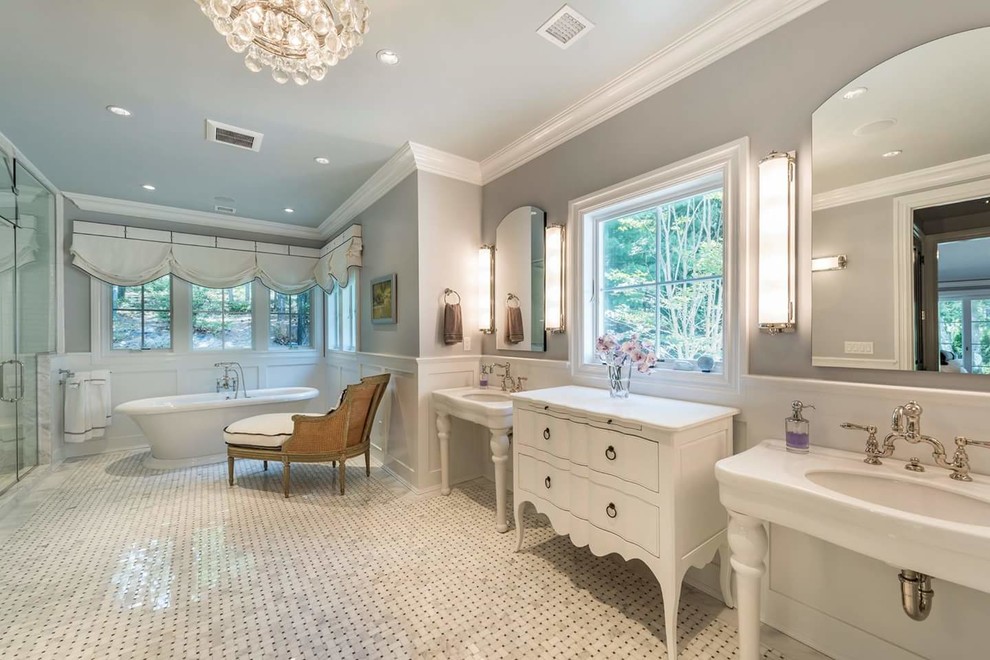 Photo of an expansive classic ensuite bathroom in New York with white cabinets, a freestanding bath, an alcove shower, white tiles, ceramic tiles, grey walls, mosaic tile flooring, a console sink and a hinged door.