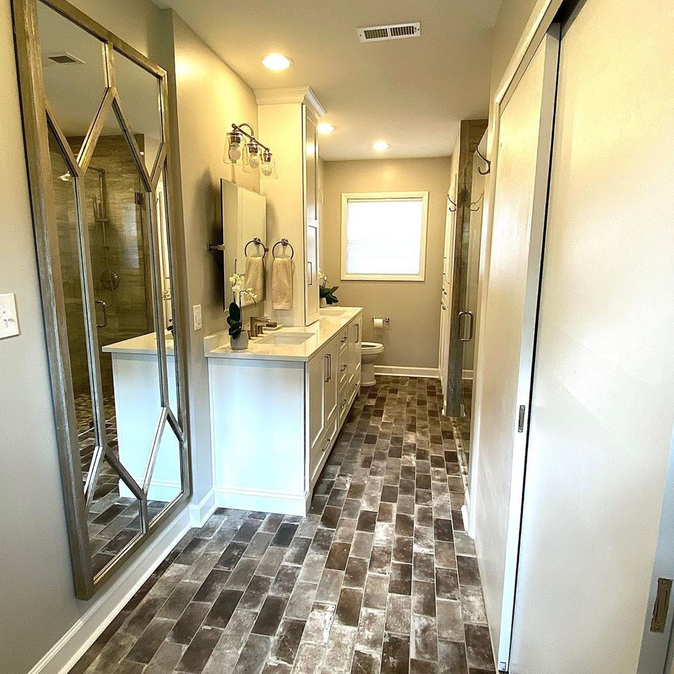 Mid-sized transitional 3/4 gray tile and porcelain tile brick floor and gray floor walk-in shower photo in Other with white cabinets, an undermount sink, quartzite countertops, a hinged shower door, white countertops, shaker cabinets and gray walls