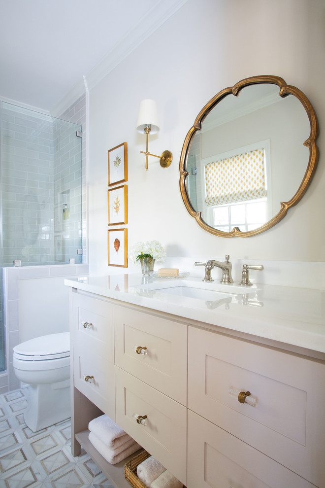 Inspiration for a traditional bathroom in Other with shaker cabinets, beige cabinets, a two-piece toilet, beige walls, mosaic tile flooring, a submerged sink, marble worktops, white floors and white worktops.