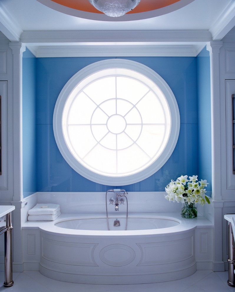 Inspiration for a traditional ensuite bathroom in New York with a submerged bath and blue walls.