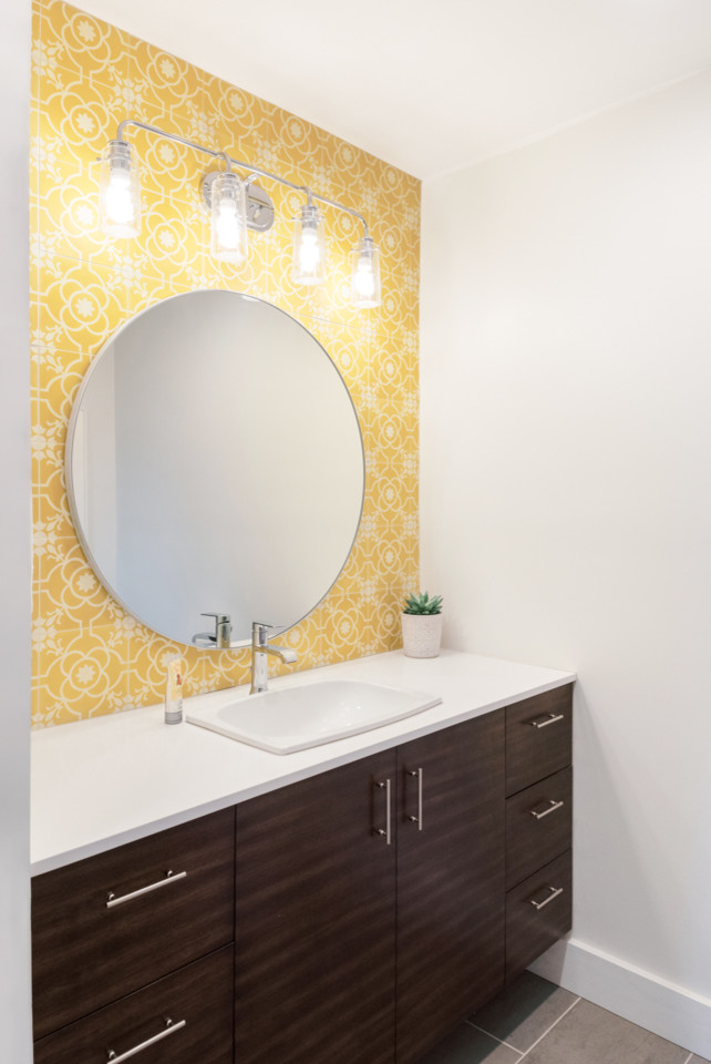 Photo of a medium sized classic ensuite bathroom in Austin with flat-panel cabinets, brown cabinets, yellow tiles, cement tiles, white walls, ceramic flooring, a built-in sink, engineered stone worktops, grey floors and white worktops.