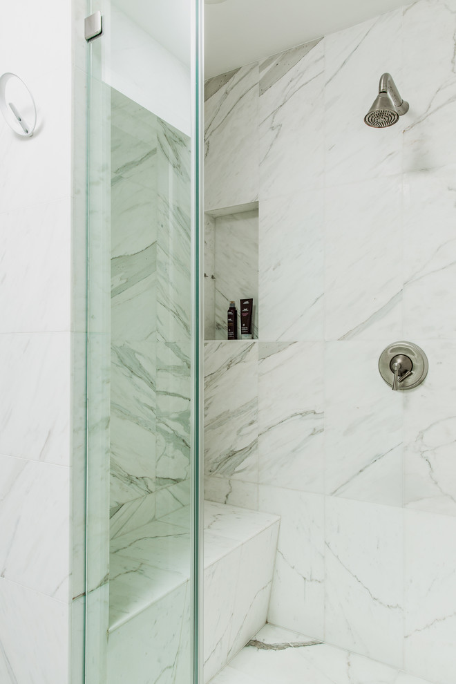 Example of a small trendy 3/4 multicolored tile and stone slab ceramic tile alcove shower design in New York with raised-panel cabinets, white cabinets, a one-piece toilet, white walls, an undermount sink and marble countertops