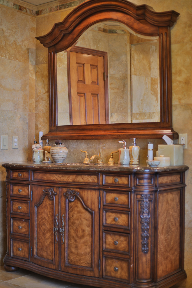 Inspiration for a large mediterranean master beige tile and stone tile travertine floor bathroom remodel in Salt Lake City with an undermount sink, furniture-like cabinets, medium tone wood cabinets, onyx countertops and a bidet
