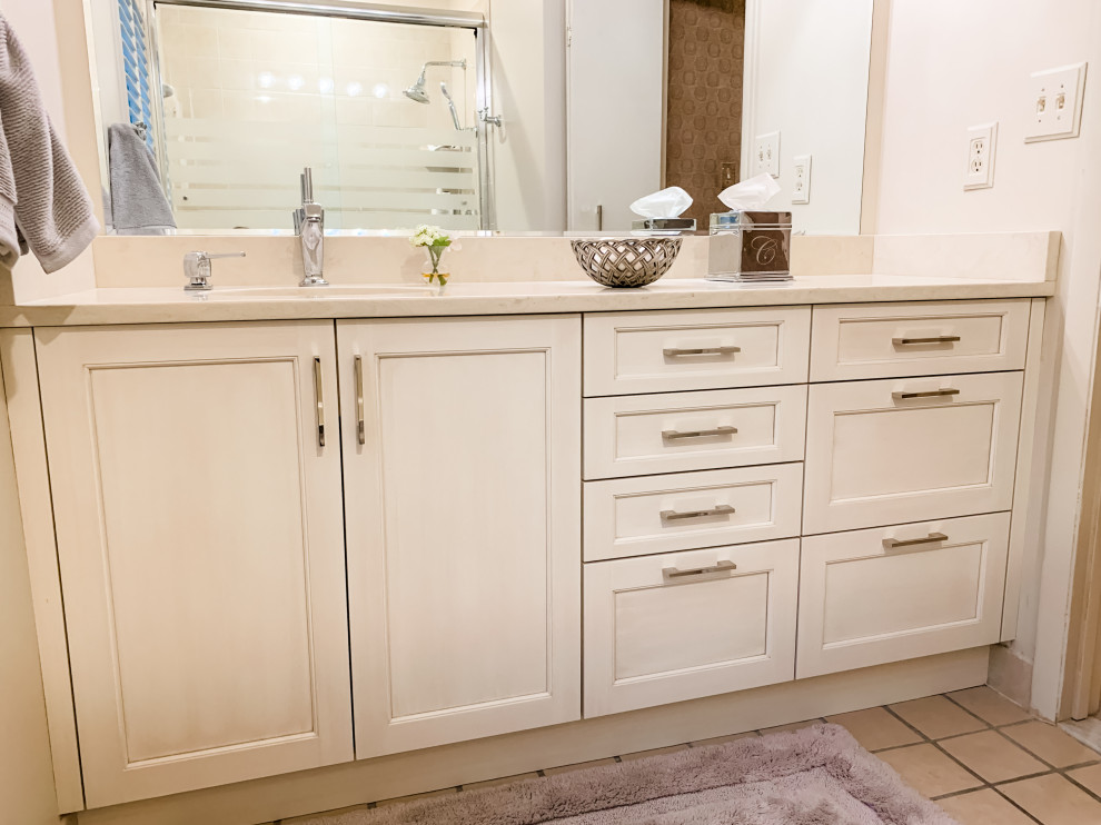 Mid-sized transitional master beige tile and ceramic tile ceramic tile, beige floor and single-sink bathroom photo in DC Metro with recessed-panel cabinets, white cabinets, a one-piece toilet, beige walls, an undermount sink, marble countertops, beige countertops and a built-in vanity