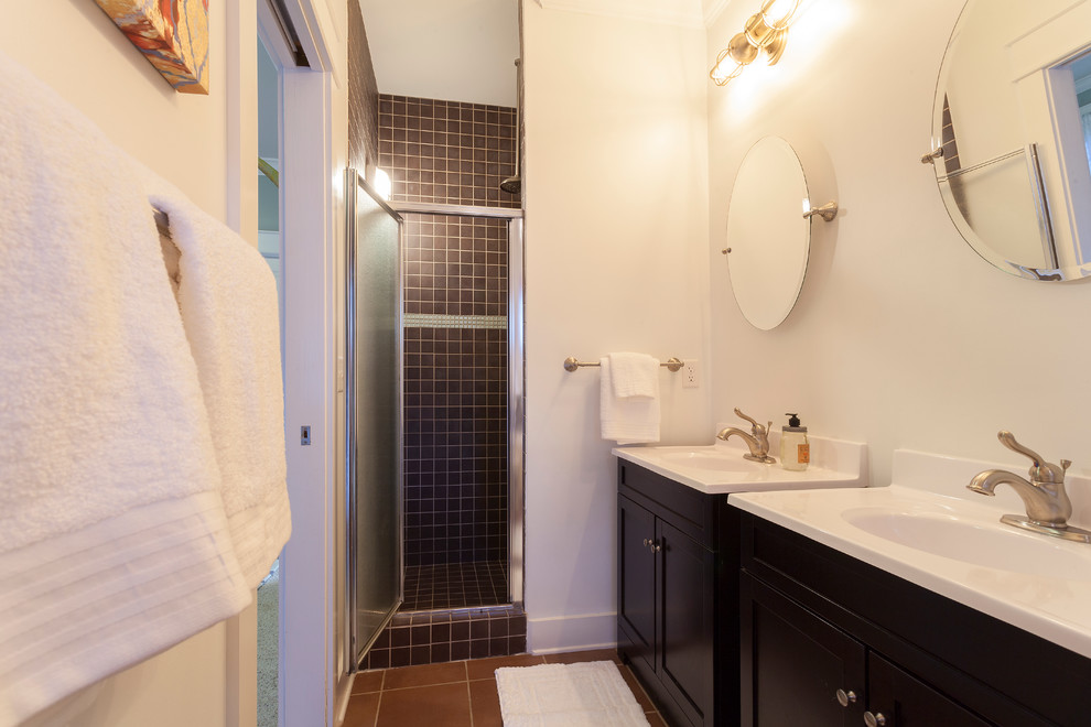 Inspiration for a mid-sized eclectic master brown tile and ceramic tile terra-cotta tile alcove shower remodel in Nashville with an integrated sink, furniture-like cabinets, dark wood cabinets, solid surface countertops and white walls
