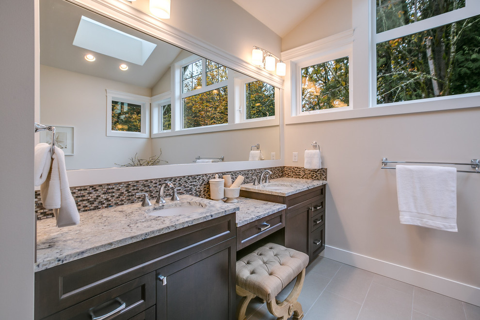 Photo of a large traditional shower room bathroom in Seattle with open cabinets, medium wood cabinets, an alcove shower, a two-piece toilet, grey tiles, porcelain tiles, grey walls, porcelain flooring, a vessel sink and granite worktops.