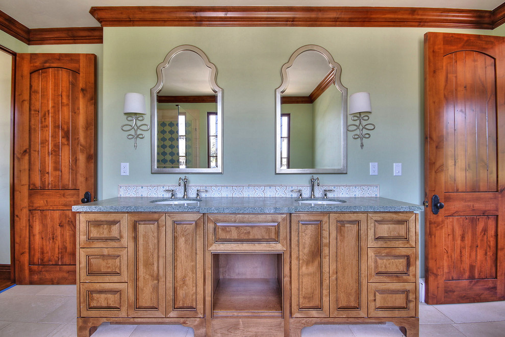 Photo of a large mediterranean family bathroom in San Francisco with recessed-panel cabinets, medium wood cabinets, green walls and a submerged sink.