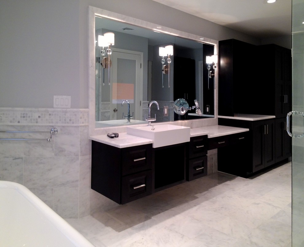 Large contemporary ensuite bathroom in Philadelphia with a trough sink, recessed-panel cabinets, dark wood cabinets, marble worktops, a freestanding bath, a corner shower, a one-piece toilet, white tiles, stone tiles, grey walls, marble flooring, white floors and a hinged door.