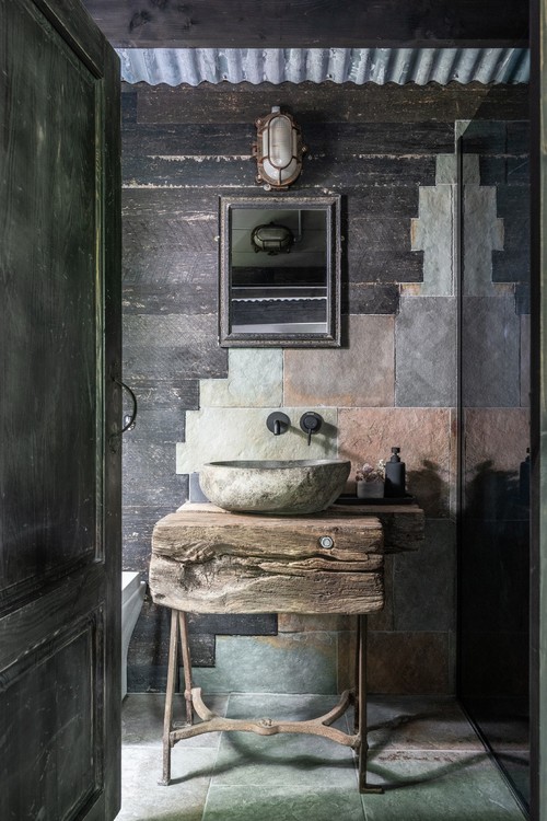 Unique Vanity and Antique Sconce in a Small Powder Room