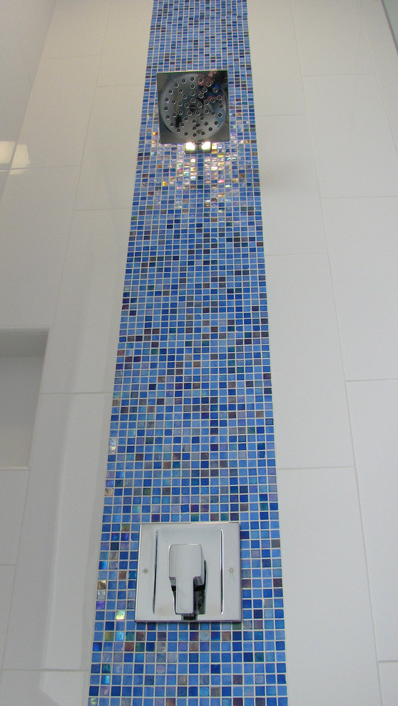 Example of a mid-sized minimalist multicolored tile and ceramic tile ceramic tile and white floor bathroom design in Austin with a vessel sink, flat-panel cabinets, white cabinets, a two-piece toilet and blue walls