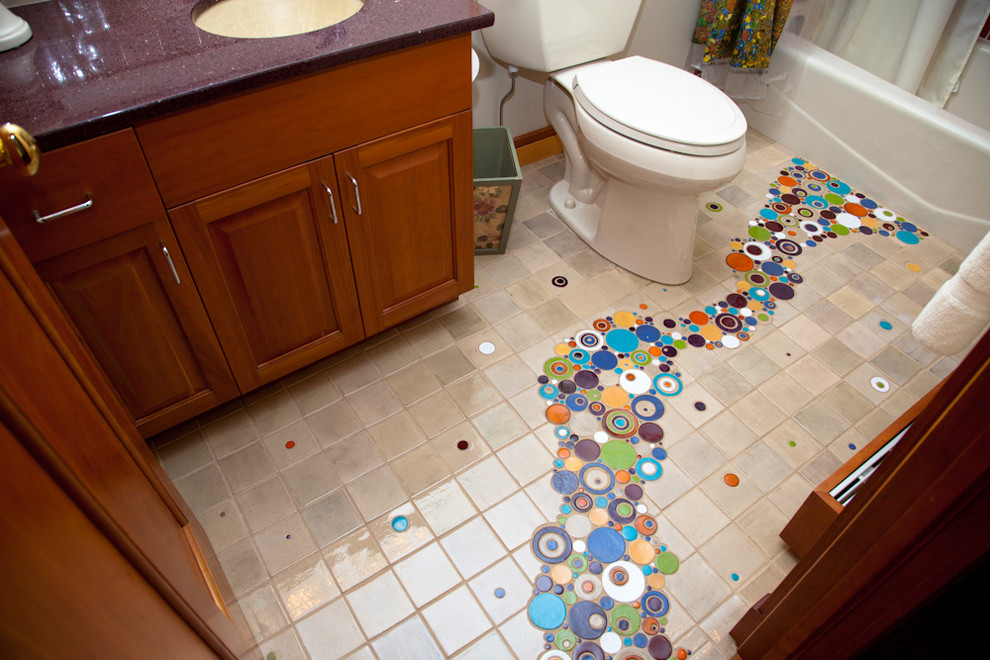 Mid-sized eclectic kids' multicolored tile and mosaic tile ceramic tile bathroom photo in Other with an undermount sink, medium tone wood cabinets, a one-piece toilet, white walls and raised-panel cabinets