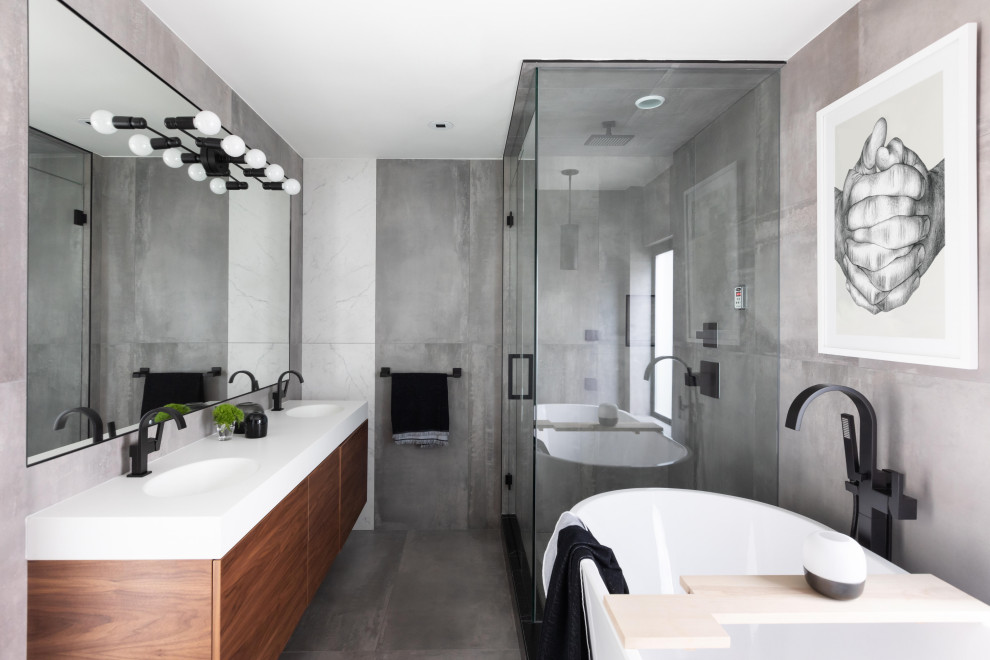 Exemple d'une salle de bain principale éclectique en bois brun avec un placard à porte plane, une douche d'angle, un carrelage gris, un mur gris, un lavabo intégré, un sol gris, une cabine de douche à porte battante, un plan de toilette blanc et une fenêtre.