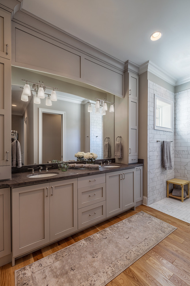 Inspiration for a medium sized traditional ensuite bathroom in Other with open cabinets, dark wood cabinets, a corner shower, a one-piece toilet, multi-coloured tiles, cement tiles, grey walls, light hardwood flooring, a submerged sink and wooden worktops.