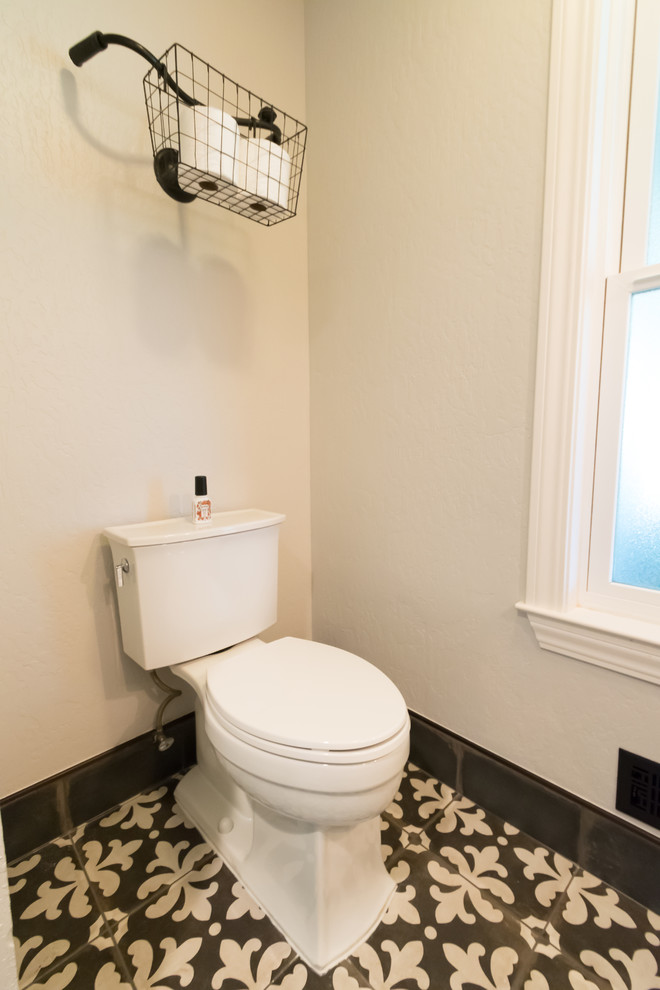Photo of a small eclectic cloakroom in San Francisco with medium wood cabinets, white walls and cement flooring.