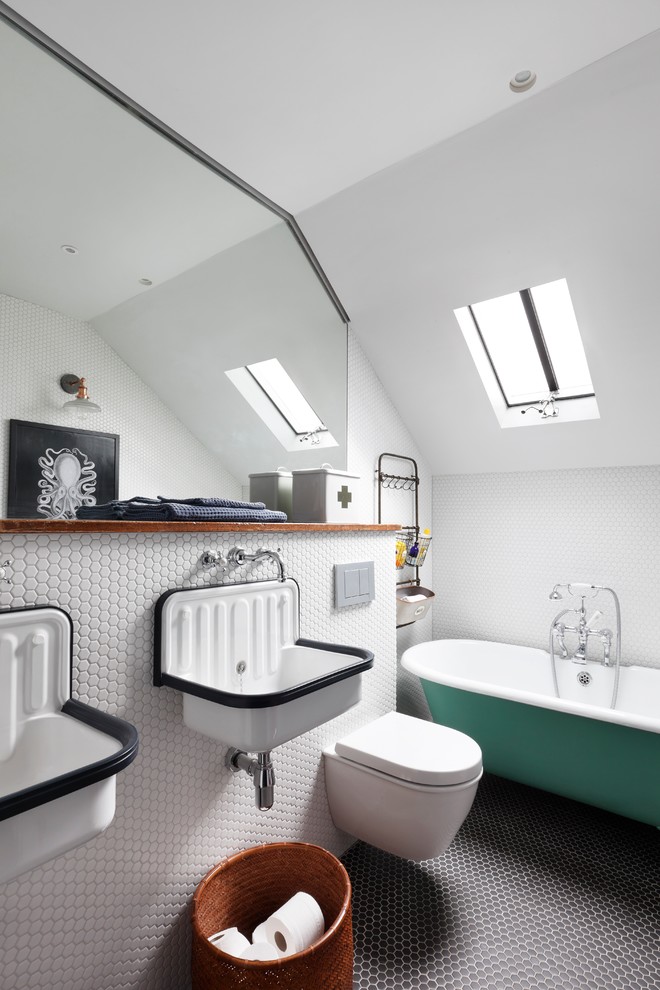 Photo of a small traditional family bathroom in London with a freestanding bath, a shower/bath combination, a wall mounted toilet, black tiles, black and white tiles, white tiles, mosaic tiles, white walls, mosaic tile flooring and a trough sink.