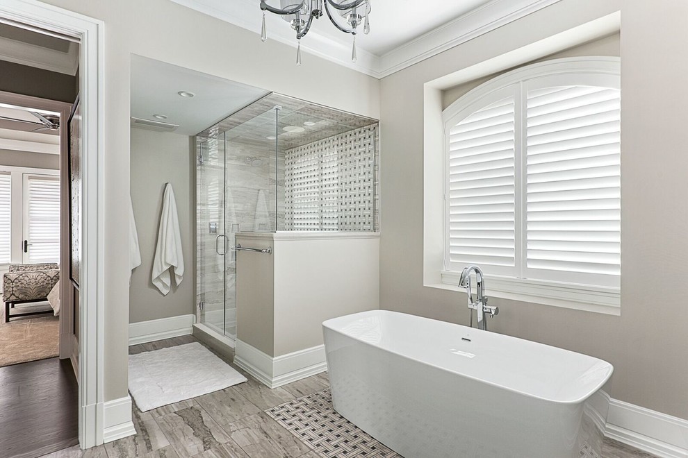 Mid-sized elegant master gray tile and ceramic tile gray floor and porcelain tile bathroom photo in Chicago with recessed-panel cabinets, quartz countertops, white cabinets, beige walls, an undermount sink, a hinged shower door and gray countertops