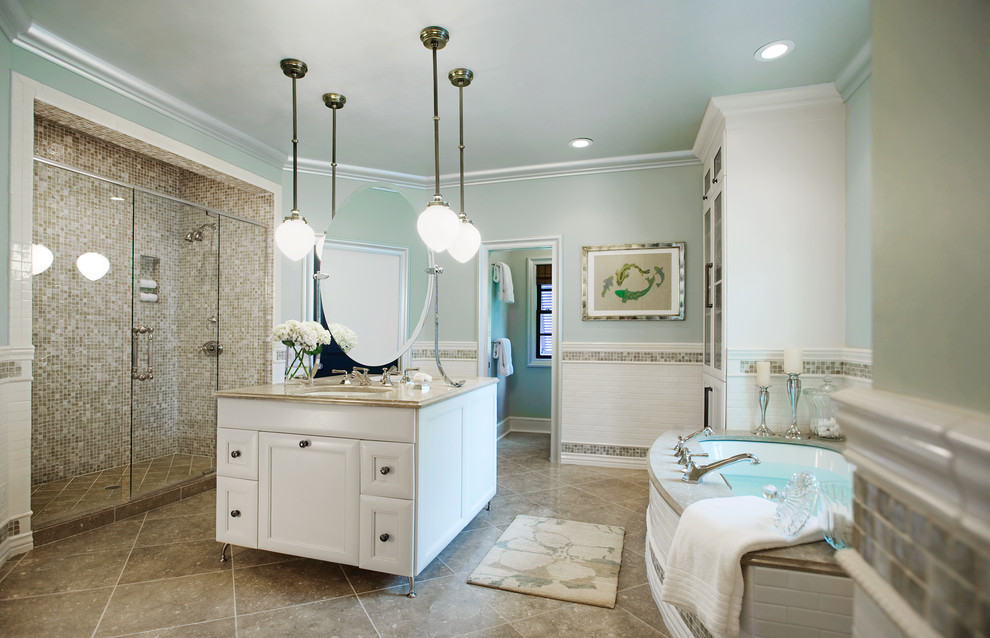 Example of an eclectic master multicolored tile and subway tile marble floor and beige floor bathroom design in Other with glass-front cabinets, white cabinets, blue walls, an undermount sink, granite countertops and a hinged shower door
