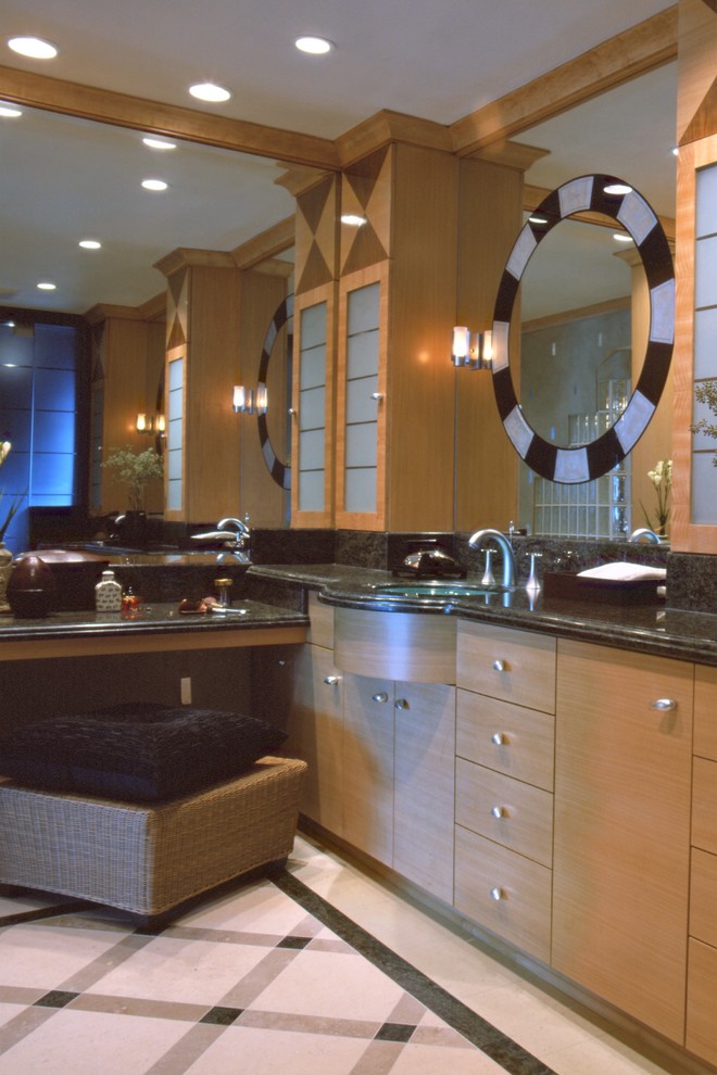 Modelo de cuarto de baño principal ecléctico grande con armarios tipo vitrina, puertas de armario de madera clara, lavabo bajoencimera y encimera de granito