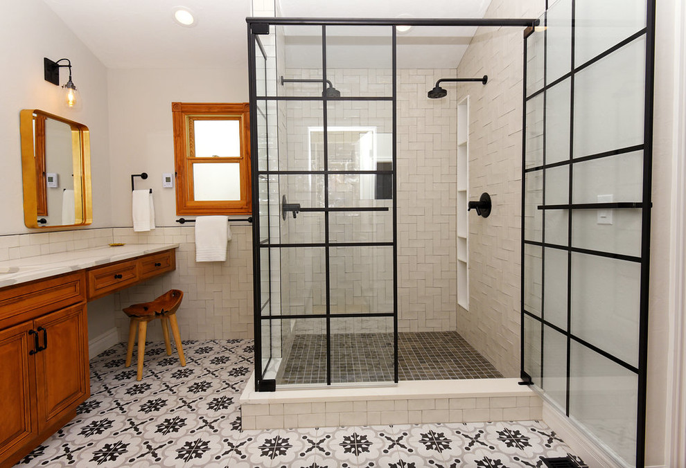 Large bohemian ensuite bathroom in Denver with raised-panel cabinets, dark wood cabinets, a double shower, white tiles, porcelain tiles, white walls, cement flooring, a submerged sink, quartz worktops, multi-coloured floors and a hinged door.