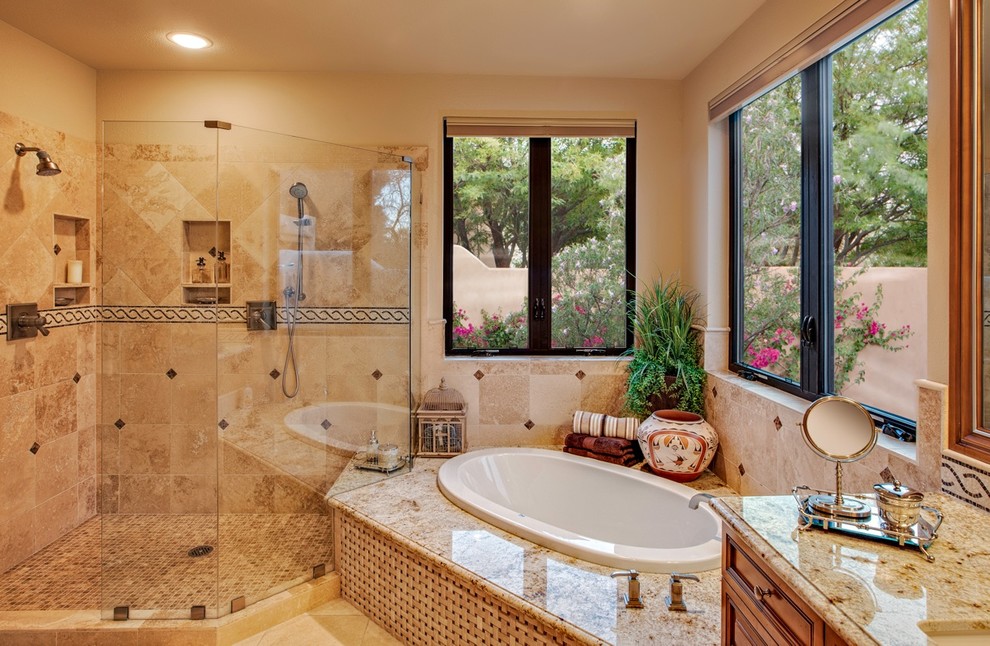Стильный дизайн: большая главная ванная комната в классическом стиле с фасадами с выступающей филенкой, фасадами цвета дерева среднего тона, накладной ванной, душем в нише, бежевыми стенами, полом из известняка, врезной раковиной и столешницей из гранита - последний тренд