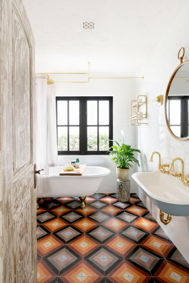 Inspiration for a mediterranean white tile and subway tile cement tile floor, multicolored floor and double-sink claw-foot bathtub remodel in Los Angeles with a wall-mount sink