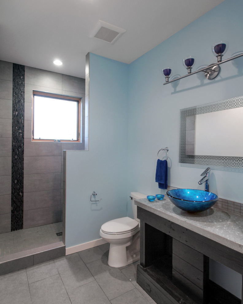 Inspiration for a medium sized modern shower room bathroom in DC Metro with a vessel sink, flat-panel cabinets, dark wood cabinets, concrete worktops, an alcove shower, a two-piece toilet, grey tiles, ceramic tiles, blue walls and porcelain flooring.