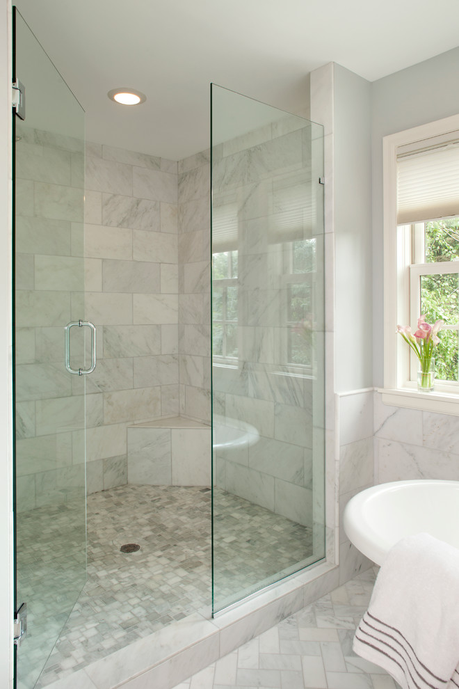 На фото: большая главная ванная комната в стиле модернизм с врезной раковиной, отдельно стоящей ванной, угловым душем, серой плиткой, мраморным полом, каменной плиткой и серыми стенами