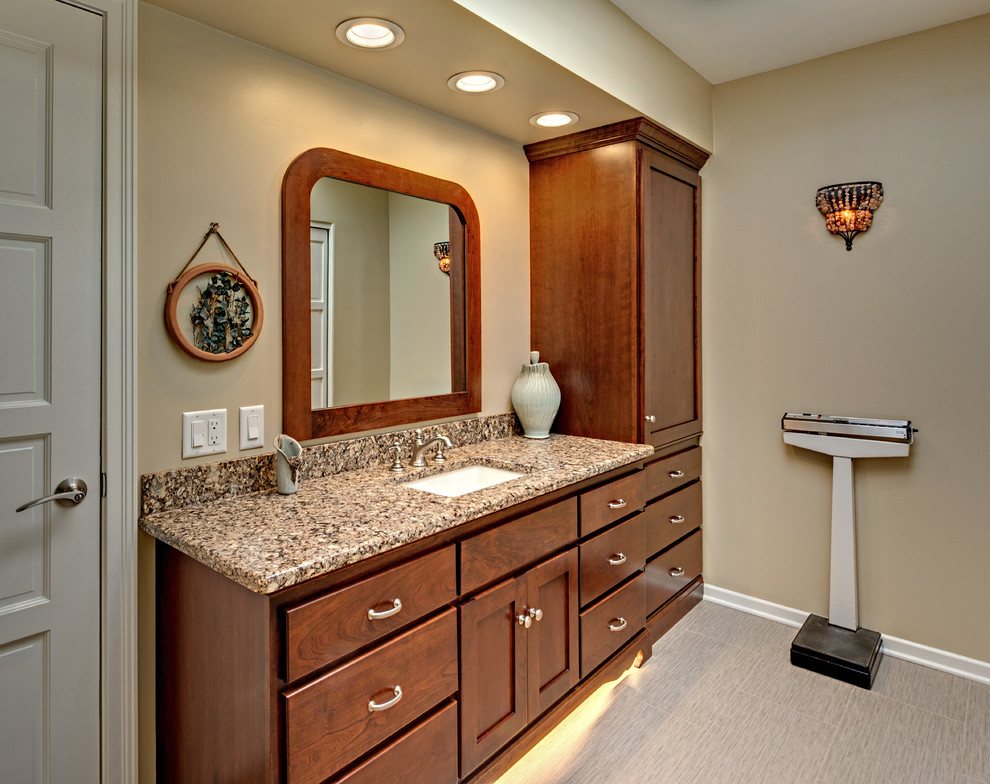 Photo of a small traditional shower room bathroom in Minneapolis with a submerged sink, freestanding cabinets, medium wood cabinets, engineered stone worktops, an alcove shower, beige tiles, porcelain tiles, beige walls, porcelain flooring and grey floors.